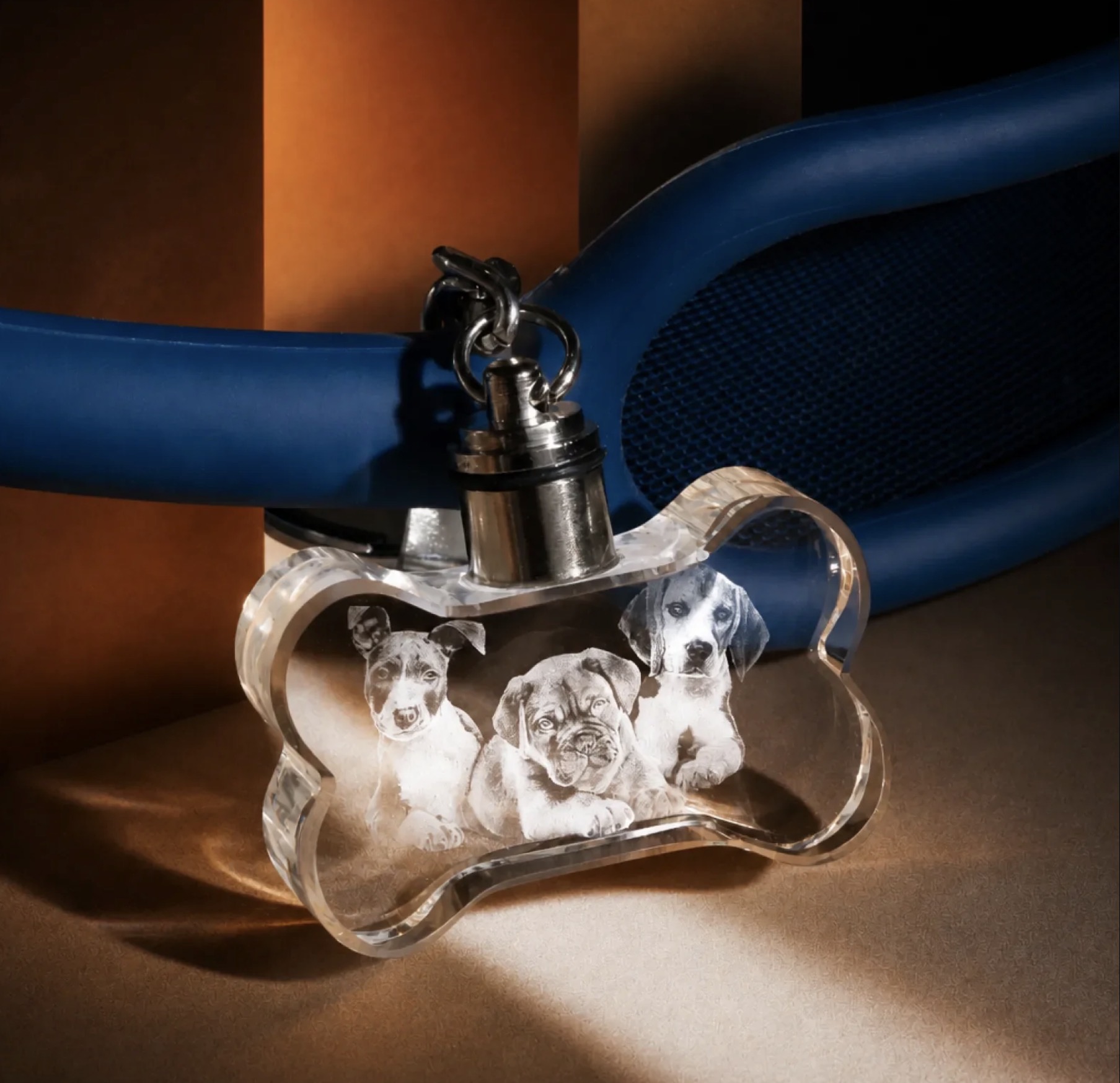 Bone-shaped crystal keychain engraved with three puppies